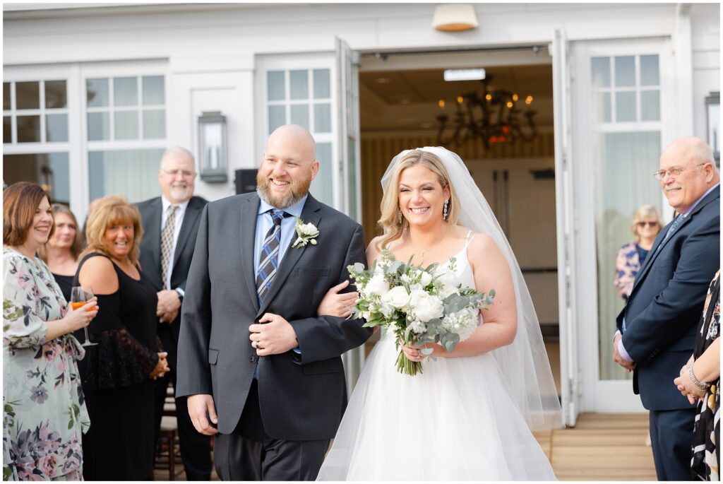 Bride walking down aisle with brother at beauport hotel
