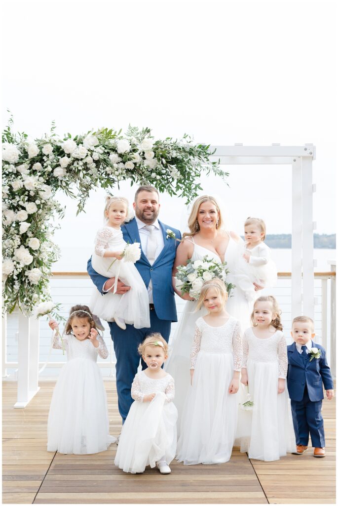 bride and groom with flower girls and ring bearer on deck A Spring Wedding at the Beauport hotel 